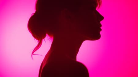 Photography, striking profile silhouette of a woman against a glowing hot pink background, captured with a wide aperture camera setup emphasizing the crisp contour of her silhouette, utilizing low ISO to enhance vivid colors and eliminate noise, photorealistic detail in ultra high definition, with aspect ratio of 9:16, slight creative tweaks to maintain a raw and compelling visual aesthetic.