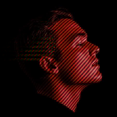 Modern art inspired by a man's side profile, featuring a minimalist overlay with a graphic design of tightly packed, alternating black and red stripes. The focal point is the precise pattern of these high-contrast lines, emphasizing their visual intensity and vibrant colors. With extreme precision in line widths and spacing, a moiré effect emerges, captivating viewers. Directly viewed from overhead, the artwork highlights the intricate interplay of light and shadow, creating an abstract yet structured motif. The composition is set against a stark backdrop, heightening the artwork's bold and dynamic presence, all in a raw, unembellished style.