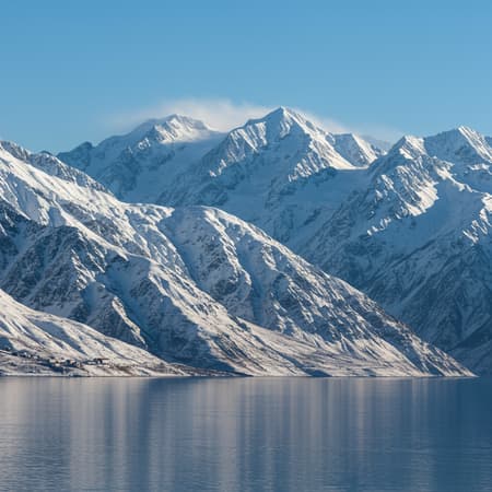 Mountains Rise Majestically, Art The distant mountains rise majestically, cloaked in a thick blanket of snow that glimmers under the brilliant sunlight. Their peaks pierce the clear blue sky, while the radiant reflections dance across the snow's surface, creating an almost blinding spectacle.