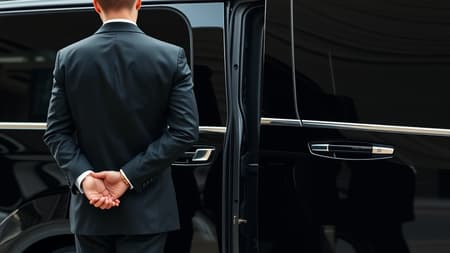 Luxurious corporate transfer service, professional chauffeur in a sleek black suit, poised beside an elegant black vehicle, focus on the meticulous craftsmanship of the back door, captured with a Leica 50mm lens, f1.4, highlighting the sophisticated details and upscale ambiance.