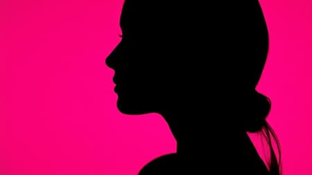 Photography shot capturing the striking contrast of a woman's profile silhouette against a vivid hot pink background, utilizing a camera setup with a large aperture to focus intensely on the sharp edge of the silhouette, while a low ISO preserves the depth and richness of the color without introducing grain, creating a photorealistic, ultra-high-definition image. The aspect ratio is tall, accentuating the elegant form, and the style is raw with minimal chaos introduced to maintain the integrity of the scene.