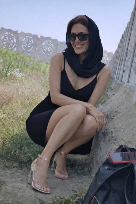 Smiling Woman In Black Dress Outdoors image-19_1.jpg